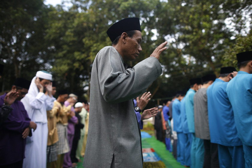 Devotees pray during Hari Raya prayers on Eid al-Fitr at Masjid Pertempatan Melayu Sembawang, one of the last 'kampung' (village) mosques untouched by development, in Singapore July 28, 2014. u00e2u20acu201d Reuters pic
