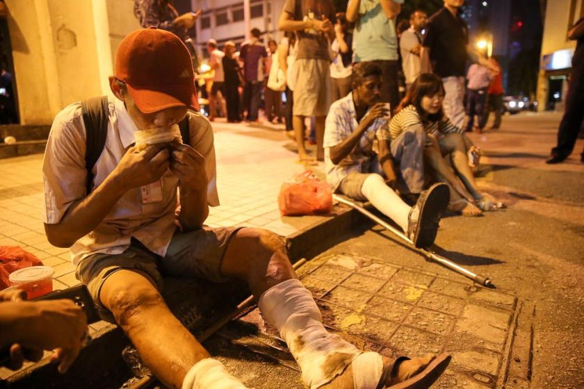A man eating the food given out by the Pertiwi soup kitchen at Jalan TAR, July 4, 2014. u00e2u20acu2022 Picture by Choo Choy May 