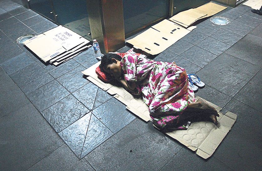 A homeless woman sleeps on the five-foot way in Pudu. NGOs hope Najib will look into the problem of homelessness seriously and come up with a solution. u00e2u20acu201d Picture by Bernama