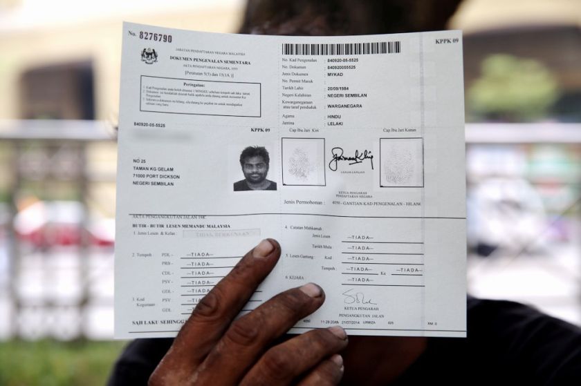 A homeless person showing off the temporary document for MyKad, July 20, 2014. — Picture by Choo Choy May