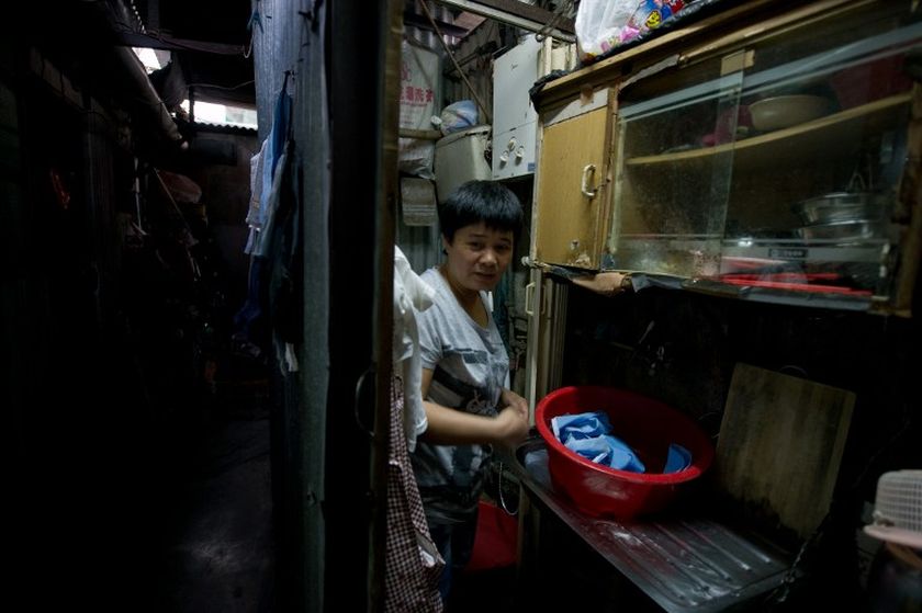 This photograph taken on October 11, 2013 shows Su Xingyun, 46, in the kitchen area opposite her two-room rooftop hut which is under a government removal order in the Sham Shui Po district of Hong Kong. u00e2u20acu201d AFP pic