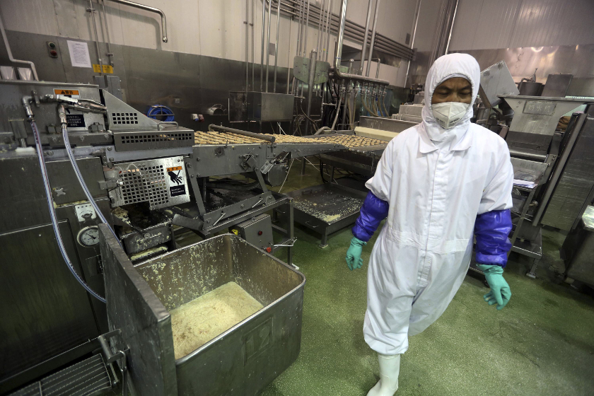 An employee works at a production line prior to a seizure conducted by officers from the Shanghai Food and Drug Administration, at the Husi Food factory in Shanghai, July 20, 2014.   u00e2u20acu201d Reuters pic