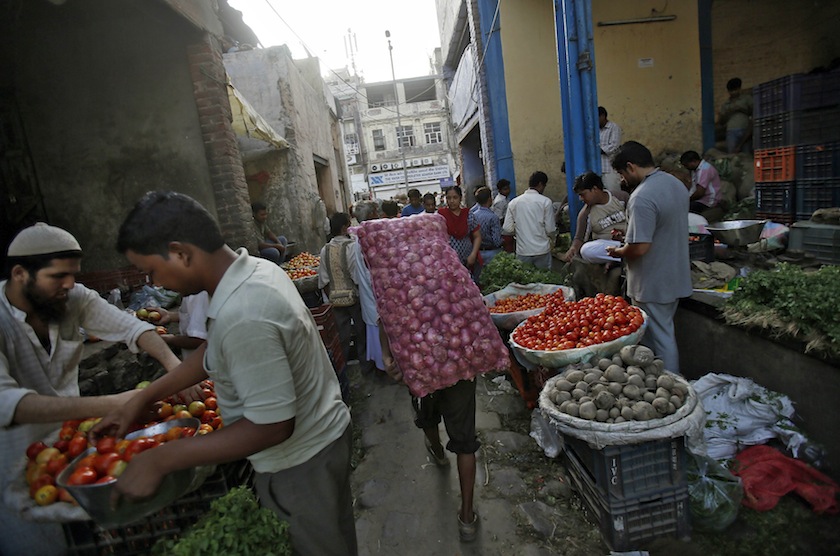 A labourer carries a sack of onions at a wholesale vegetable market in the old quarters of Delhi July 10, 2014. u00e2u20acu201du00c2u00a0Reuters pic
