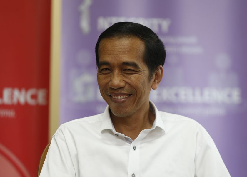Indonesia's presidential candidate Joko Widodo smiles during a talk with his supporters at the Bisnis Indonesia newspaper office in Jakarta, July 21, 2014. u00e2u20acu2022 Reuters pic