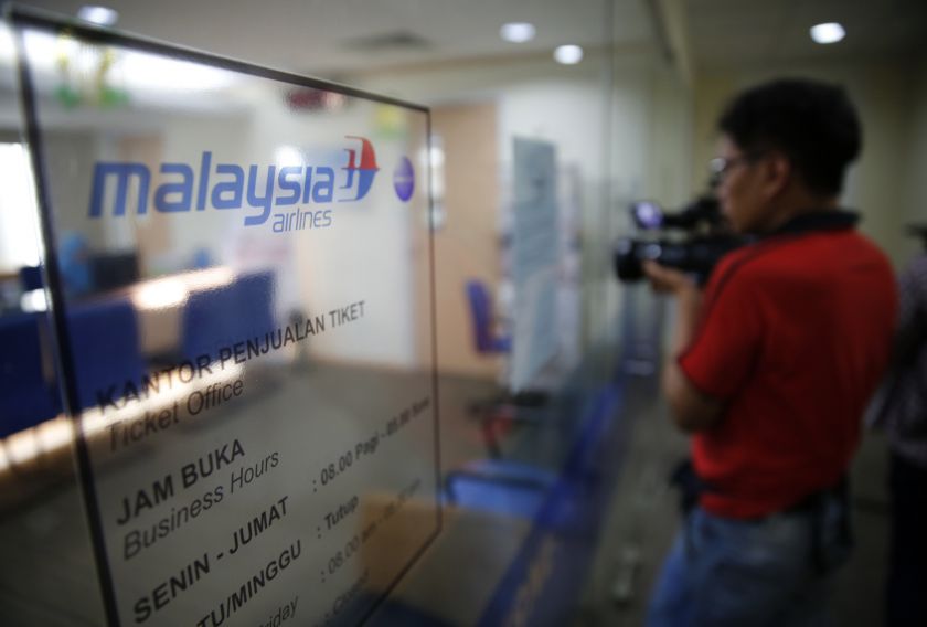 A journalist films the Malaysia Airlines ticket office in Jakarta July 18, 2014. World leaders demanded an international investigation into the shooting down of Malaysia Airlines Flight MH17 with 298 people on board over eastern Ukraine. u00e2u20acu201d Reuters pic