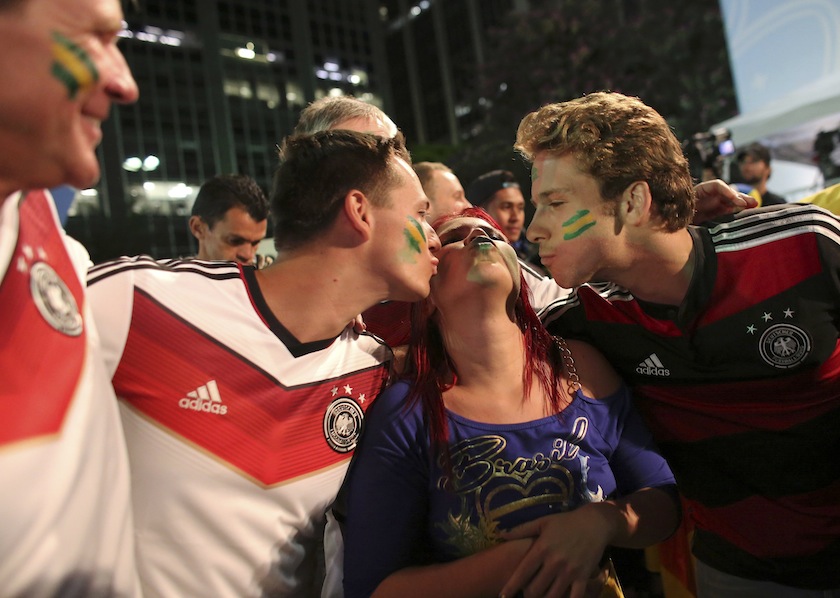 Germany fans kiss a Brazilian fan at the end of a broadcast of the 2014 World Cup semi- final soccer match between Brazil and Germany in Sao Paulo, July 9, 2014.u00c2u00a0u00e2u20acu201d Reuters pic