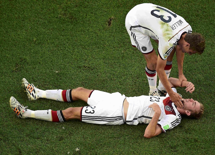 Germany's Thomas Mueller (top) helps up teammate Christoph Kramer during their 2014 World Cup final against Argentina at the Maracana stadium in Rio de Janeiro July 14, 2014.u00c2u00a0u00e2u20acu201du00c2u00a0Reuters pic