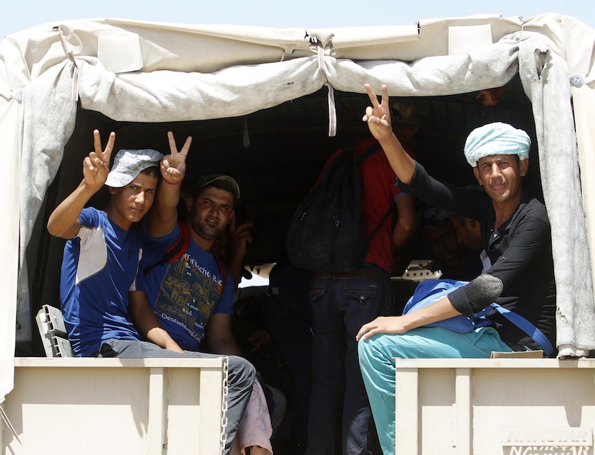 Shi'ite volunteers, who have joined the Iraqi army to fight against militants of the Islamic State, flash signs to the camera from inside a truck in Baghdad July 9, 2014. u00e2u20acu201d Reuters pic