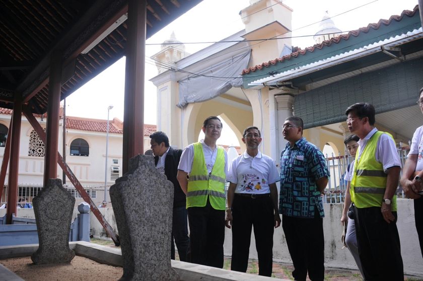 Penang Chief Minister Lim Guan Eng looks at the tombstone of Lebuh Acheh mosque founder Tengku Syed Hussain Idid during his walk around the area as the state holds this year's Penang Heritage World Celebration, July 7, 2014. — Picture by KE Ooi