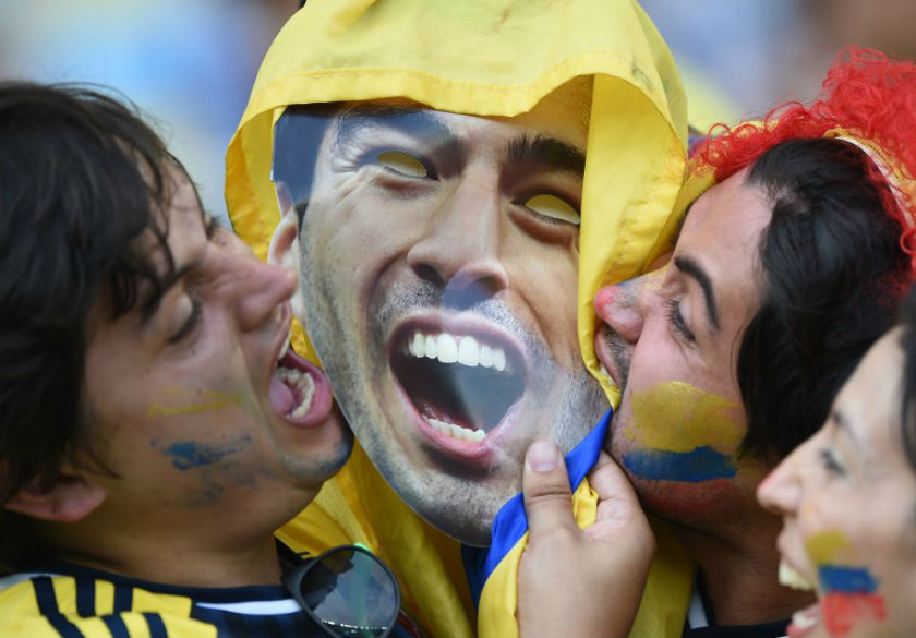 Fans mock bite a cardboard cut outs of Uruguayan forward Luis Suarez prior to the Round of 16 football match between Colombia and Uruguay at the Maracana Stadium in Rio de Janeiro during the 2014 FIFA World Cup in Brazil on June 28, 2014. u00e2u20acu201d AFP pic