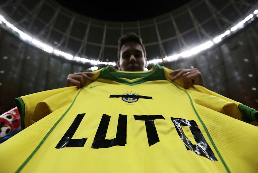 A fan holds a Brazilian jersey after their loss to the Netherlands in their 2014 World Cup third-place playoff at the Brasilia national stadium in Brasilia July 13, 2014. The word on the jersey reads 'Mourning'. u00e2u20acu201d Reuters pic