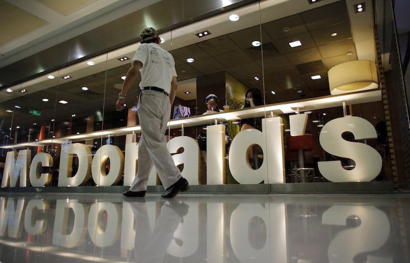 A man walks next to a McDonaldu00e2u20acu2122s restaurant at a shopping mall in Shanghai July 28, 2014. u00e2u20acu201d Reuters pic