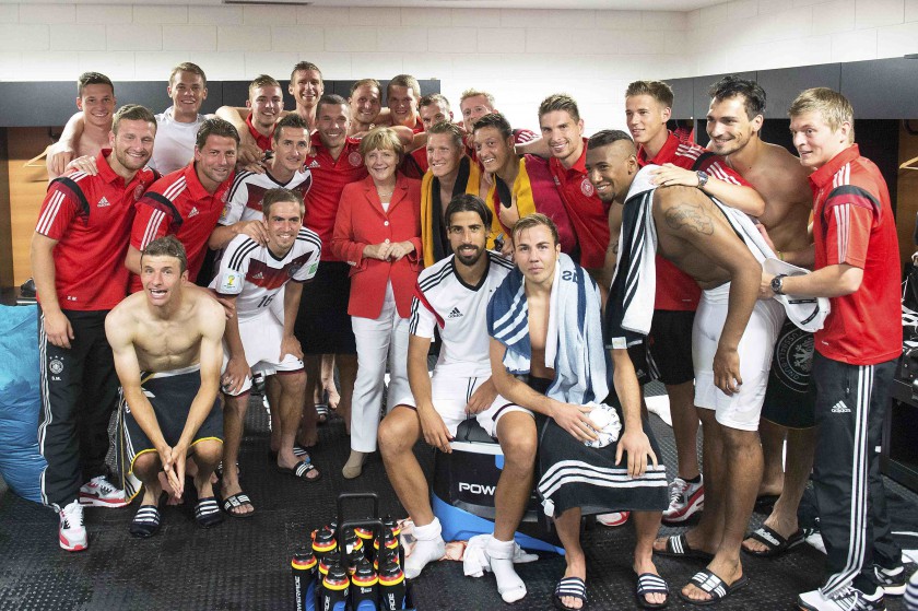 File picture shows German Chancellor Angela Merkel posing with the German national squad following their victory over Portugal in their World Cup match in Salvador, Brazil, June 16, 2014. u00e2u20acu201d Reuters pic