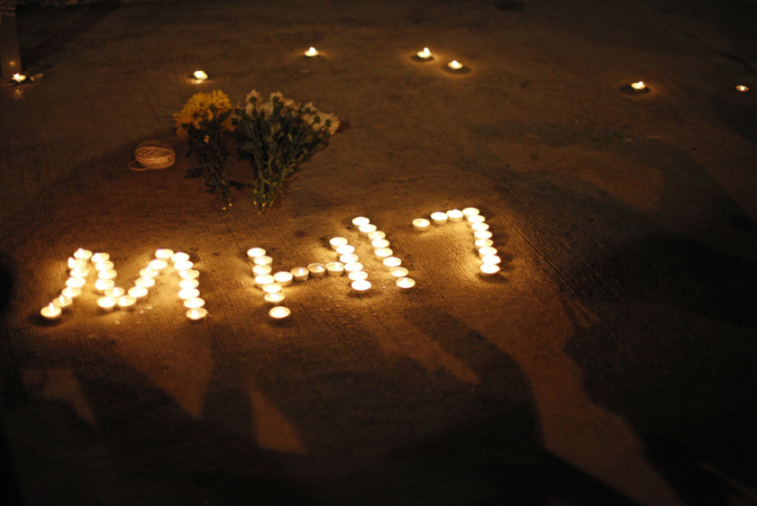 People take pictures of an MH17 sign during a candlelight vigil near Chinatown in Kuala Lumpur July 20, 2014. u00e2u20acu201d Reuters pic