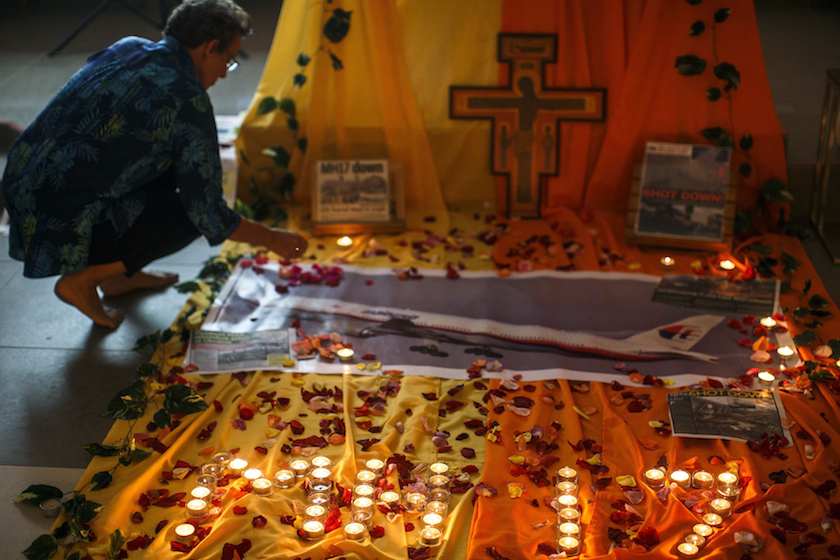 A woman lights candles at a memorial for victims of the downed Malaysia Airlines Flight MH17 in Kuala Lumpur July 18, 2014. u00e2u20acu201d Reuters pic