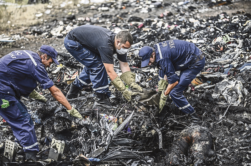 Ukrainian State Emergency Service employees search for bodies amongst the wreckage at the crash site of MAS flight MH17, near the village of Grabove, in the region of Donetsk on July 20, 2014. — AFP pic