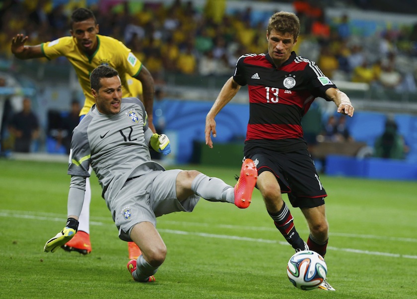 Brazil's goalkeeper Julio Cesar (left) fights for the ball with Germany's Thomas Mueller as teammate Luiz Gustavo looks on during their 2014 World Cup semi-finals at the Mineirao stadium in Belo Horizonte July 9, 2014.u00c2u00a0u00e2u20acu201d Reuters pic
