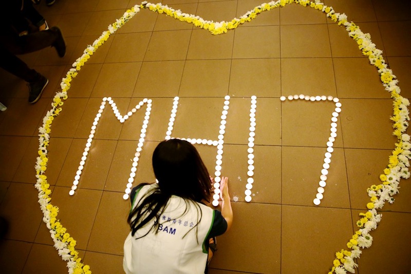A girl lights up a candle during Pray For MH17 at KLSCAH. u00e2u20acu201d Picture by Choo Choo May