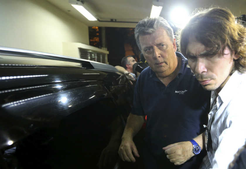 Ray Whelan (left), of Switzerland-based Match Services, arrives at a police station after being arrested in Rio de Janeiro July 7, 2014. u00e2u20acu201d Reuters pic