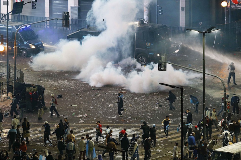 Argentina's fans clash with riot police after Argentina lost to Germany in their 2014 World Cup final match in Brazil, at a public square viewing area in Buenos Aires, July 14, 2014. — Reuters pic