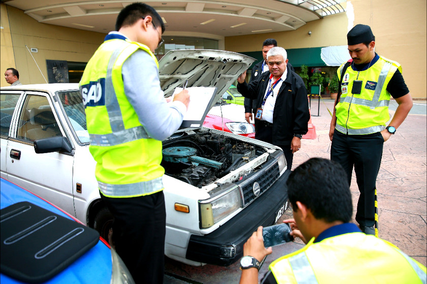 Land Public Transport Commission (SPAD) officials conduct a check on taxi drivers in Kuala Lumpur, on July 14, 2014. u00e2u20acu201d Picture by Saw Siow Feng