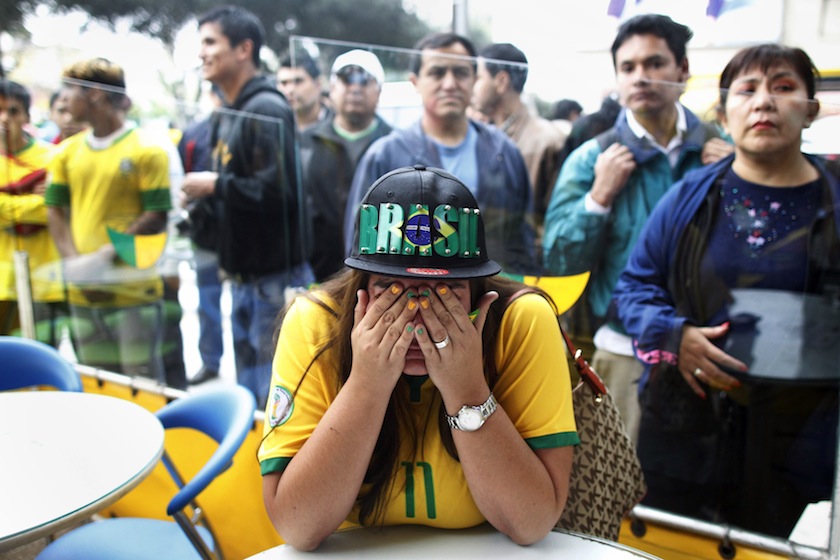 A Brazilian fan reacts after watching a live broadcast match where Brazil was beaten by Germany in the 2014 World Cup semi-finals, at a Brazilian restaurant in Lima July 9, 2014.u00c2u00a0u00e2u20acu201du00c2u00a0Reuters pic