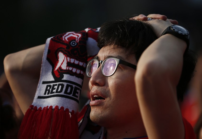 A South Korean football fan reacts while watching a live television broadcast after their team was defeated by Belgium in their 2014 World Cup Group H match, in Seoul June 27, 2014. u00e2u20acu201d Reuters pic