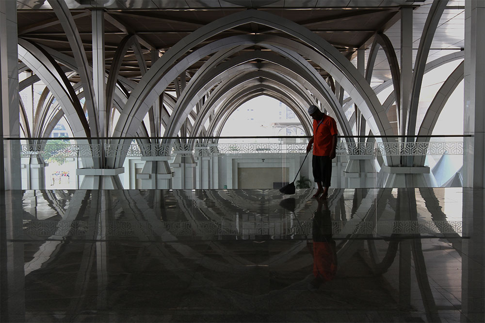A worker cleans the floor of the Tuanku Mizan Mosque in Putrajaya, July 7, 2014.u00e2u20acu201d Picture by Yusof Mat Isa