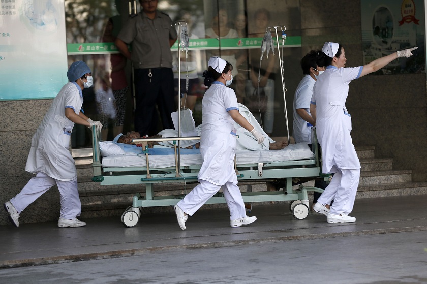 Medical personnel transport a victim of a factory explosion, at a hospital in Kunshan, Jiangsu province, August 2, 2014. u00e2u20acu201d Reuters pic