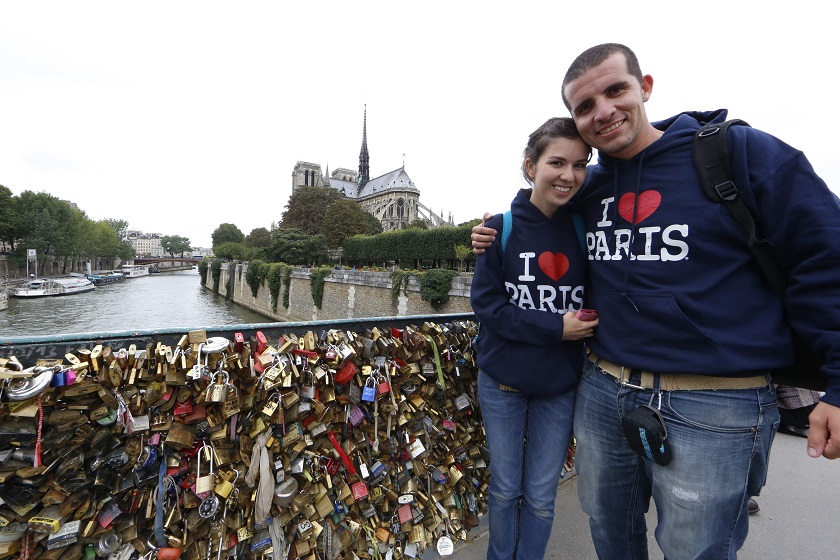 Mexican tourists, Claudia and Oswaldo, pose on the Pont de lu00e2u20acu2122Archeveche bridge, which is covered with thousands of padlocks, called love locks, near the Notre Dame Cathedral in Paris August 13, 2014. u00e2u20acu201d Reuters pic