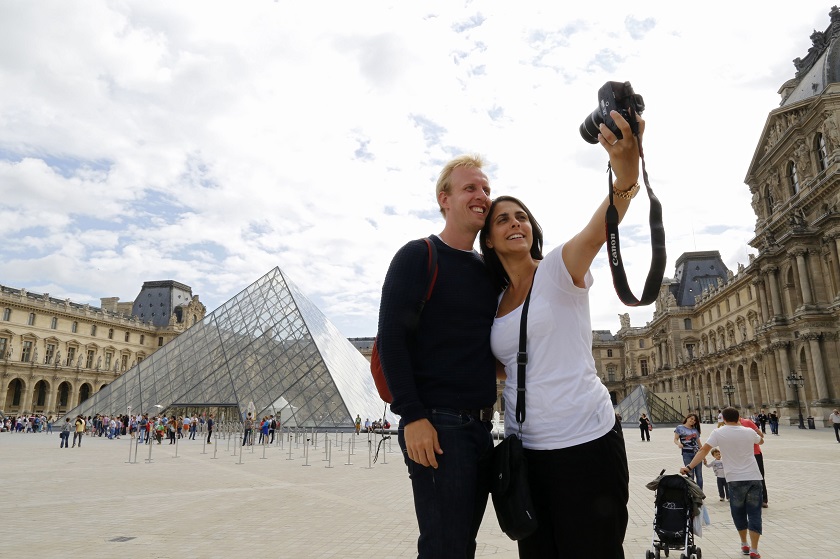 Australian tourists pose for a souvenir self-portrait near the Pyramid of the Louvre Museum in Paris, August 12, 2014. u00e2u20acu201d Reuters pic