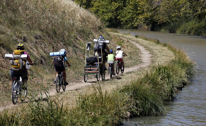 A family rides bikes near the Canal du Midi, near Homps, southwestern France, August 12, 2014, during summer holidays. u00e2u20acu201d Reuters pic