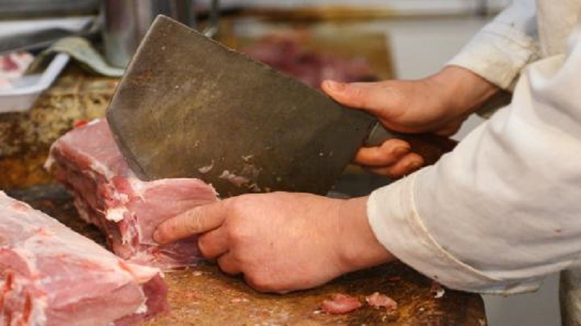 A butcher chops pork at a market in Shanghai. u00e2u20acu201d AFP pic