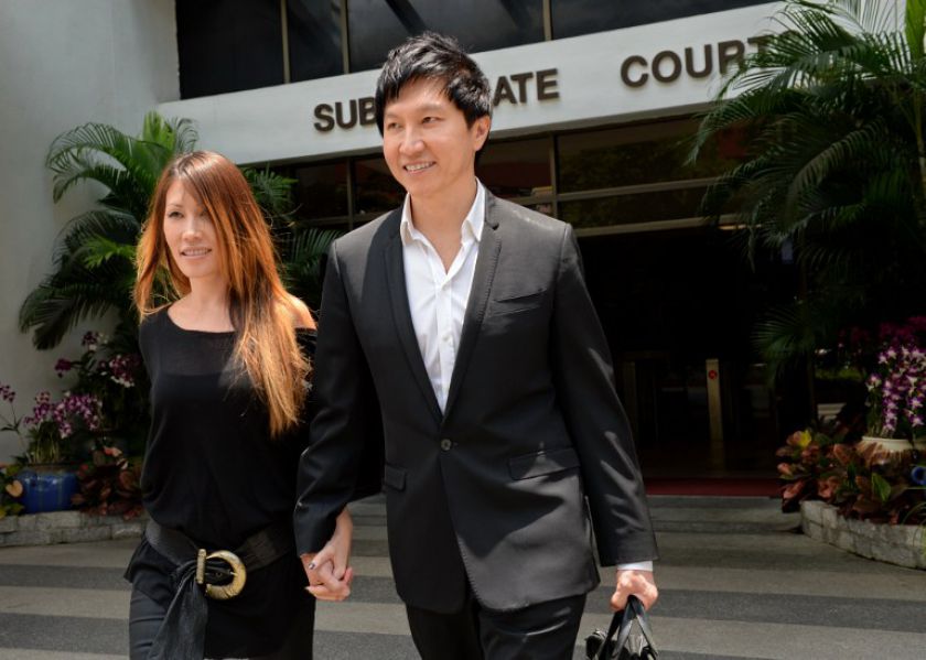 File picture shows City Harvest Church founder Kong Hee (right) with his pop-singer wife Ho Yeow Sun (left) outside the district courts in Singapore in August 2013. u00e2u20acu201d AFP pic