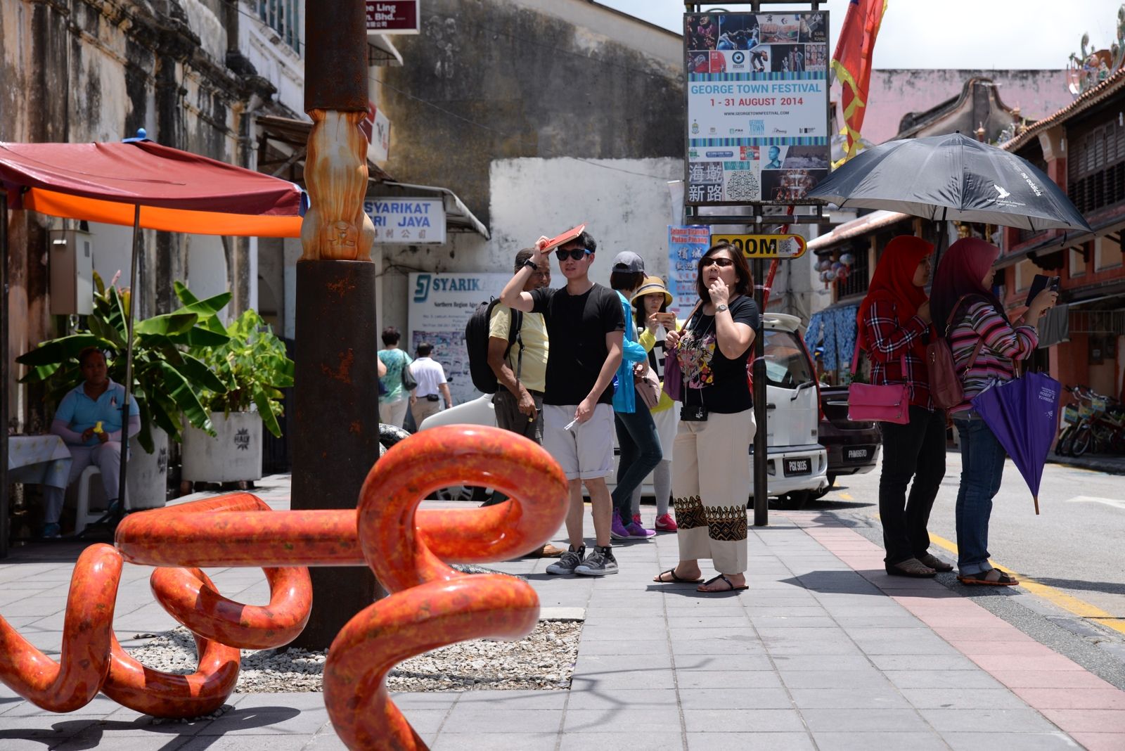 Tourists admiring an installation at Lebuh Armenian during the George Town Festival in Penang, August 21, 2014. — Picture by K.E. Ooi