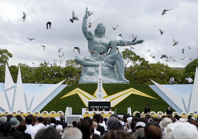 Doves fly near the Peace Statue in Nagasaki's Peace Park during a ceremony commemorating the 69th anniversary of the bombing of the city in Nagasaki, August 9, 2014 Reuters