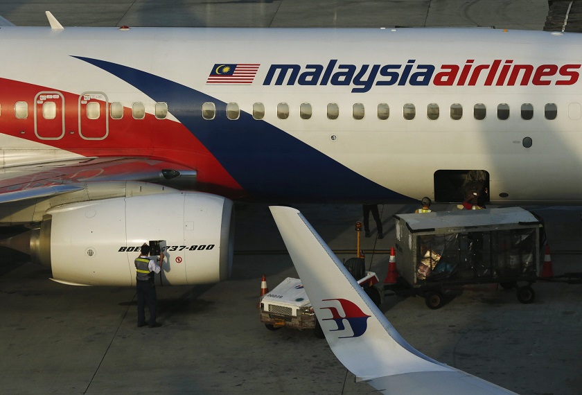 A member of ground crew works on a Malaysia Airlines Boeing 737-800 airplane on the runway at Kuala Lumpur International Airport in Sepang July 25, 2014. u00e2u20acu201d Reuters pic 