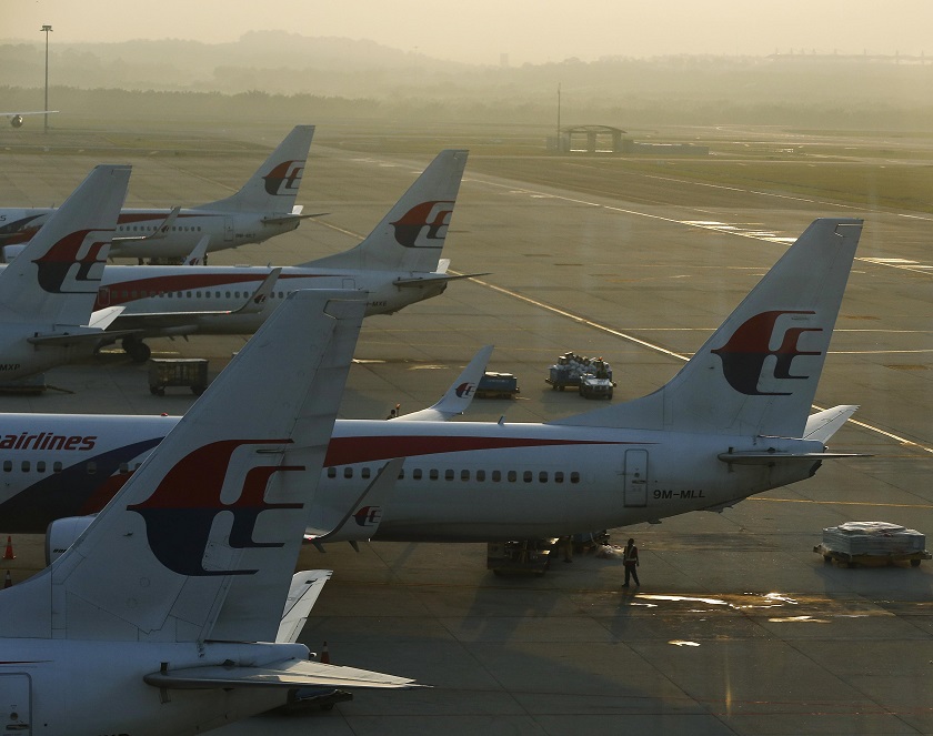 A member of ground crew walks underneath a Malaysia Airlines plane on the runway at Kuala Lumpur International Airport July 25, 2014. u00e2u20acu201d Reuters pic 