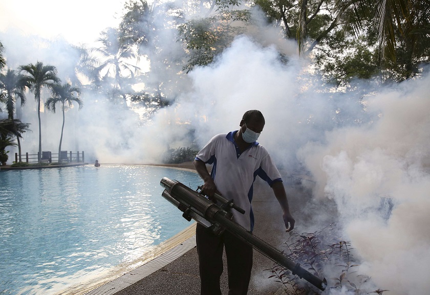 A pest control worker sprays insecticide to help control the spread of dengue fever carried by mosquitoes in Kuala Lumpur August 27, 2014.  u00e2u20acu201d Reuters pic 