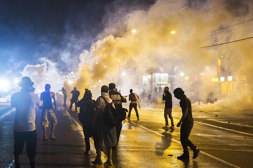 Protesters walk through smoke as police clear a street after the passing of a midnight curfew meant to stem ongoing demonstrations in reaction to the shooting of Michael Brown, in Ferguson, Missouri August 18, 2014. u00e2u20acu201d Reuters pic