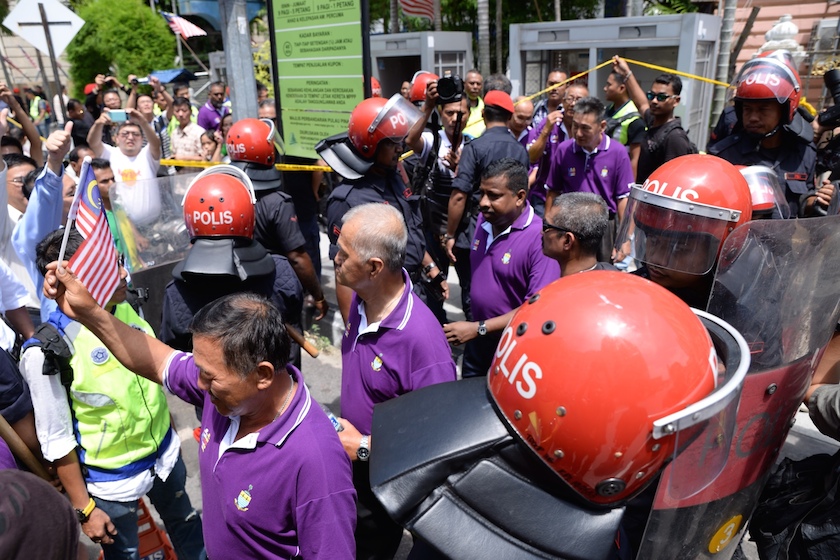 The detained PPS members being escorted from the Beach Street police station to a bus bound for the George Town police headquarters on Jalan Patani August 31, 2014. u00e2u20acu201d Picture by K.E. Ooi