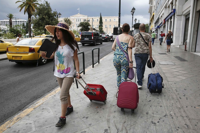 Tourists make their way around central Syntagma square in Athens July 24, 2014.  u00e2u20acu201d Reuters  pic