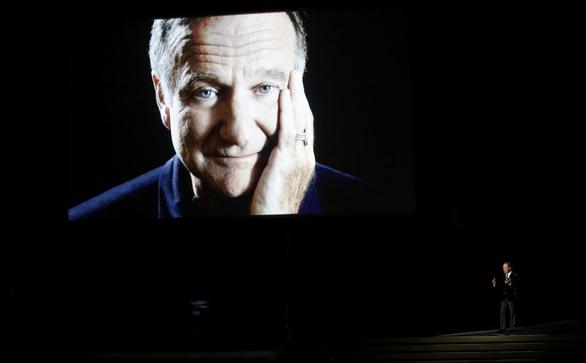 Billy Crystal takes the stage to pay tribute to the late Robin Williams, shown on a large screen, during the 66th Primetime Emmy Awards in Los Angeles, California August 25, 2014. u00e2u20acu201d Reuters pic