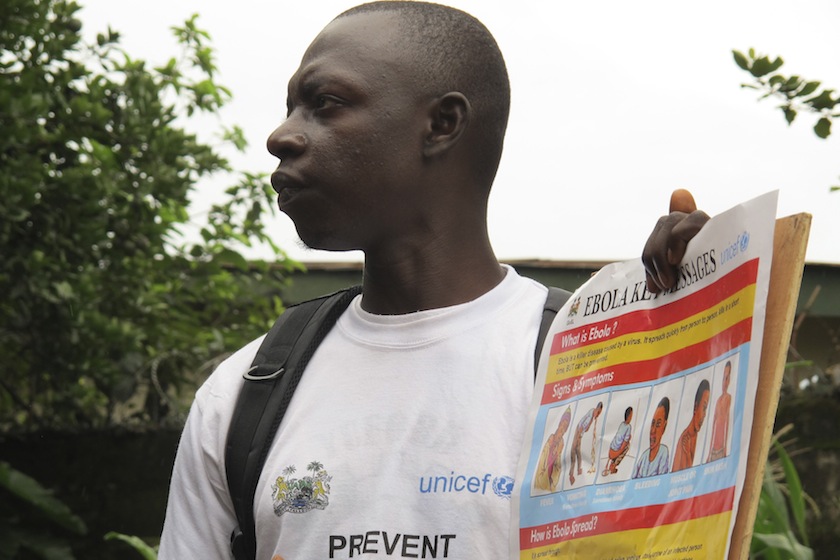 An outreach worker holds a poster bearing information on the symptoms of Ebola virus disease (EVD) and best practices to help prevent its spread, in Freetown, Sierra Leone in this August, 2014 handout photo provided by UNICEF August 6, 2014.u00c2u00a0u00e2u20acu201d Reuters 