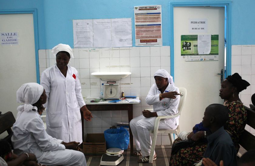 Nurses talk near a poster (C) displaying a government message against Ebola, at a maternity hospital in Abidjan August 14, 2014.  u00e2u20acu201d Reuters pic