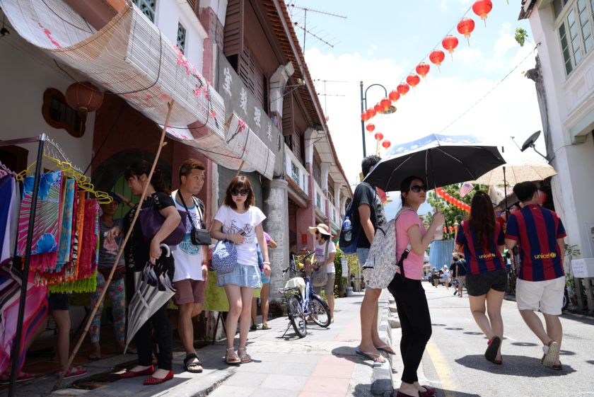 Tourist looking at the exhibited art craft along Armenian Street during the George Town Festival in Penang, August 21, 2014. u00e2u20acu201dPicture by K.E. Ooin