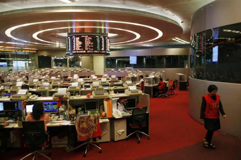 A trader walks inside the trading hall during afternoon trading at the Hong Kong Stock Exchange April 10, 2014. u00e2u20acu201d Reuters pic