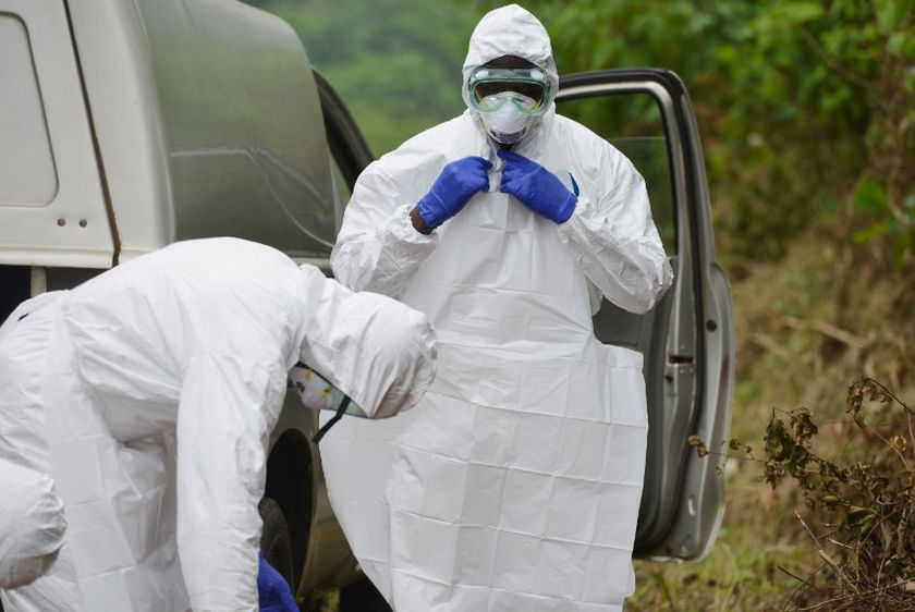 A man prepares to take off his protective suit at Biankouma's hospital during a simulation, on August 14, 2014. u00e2u20acu201d AFP picn
