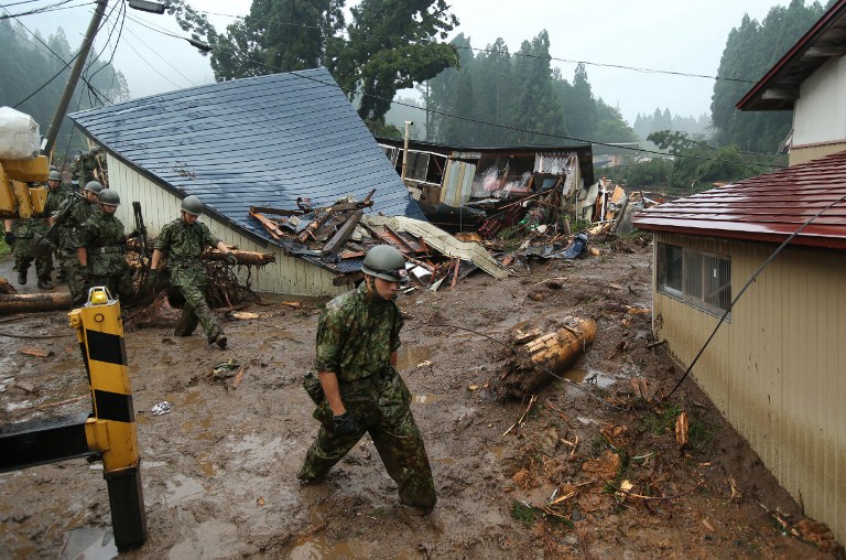 File picture shows Japanese Ground Self Defense Forces searching for missing victims among debris of houses following floods near Lake Tazawa in Semboku, Akita prefecture on August 10, 2013. u00e2u20acu201d AFP pic