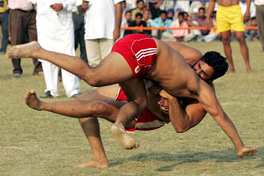 An Indian kabbadi player (left) is brought to the ground during the 2008 Sri Guru Gobind Singh Kabaddi Series in Gopalpur Majwind village, November 9, 2008. u00e2u20acu201d AFP pic